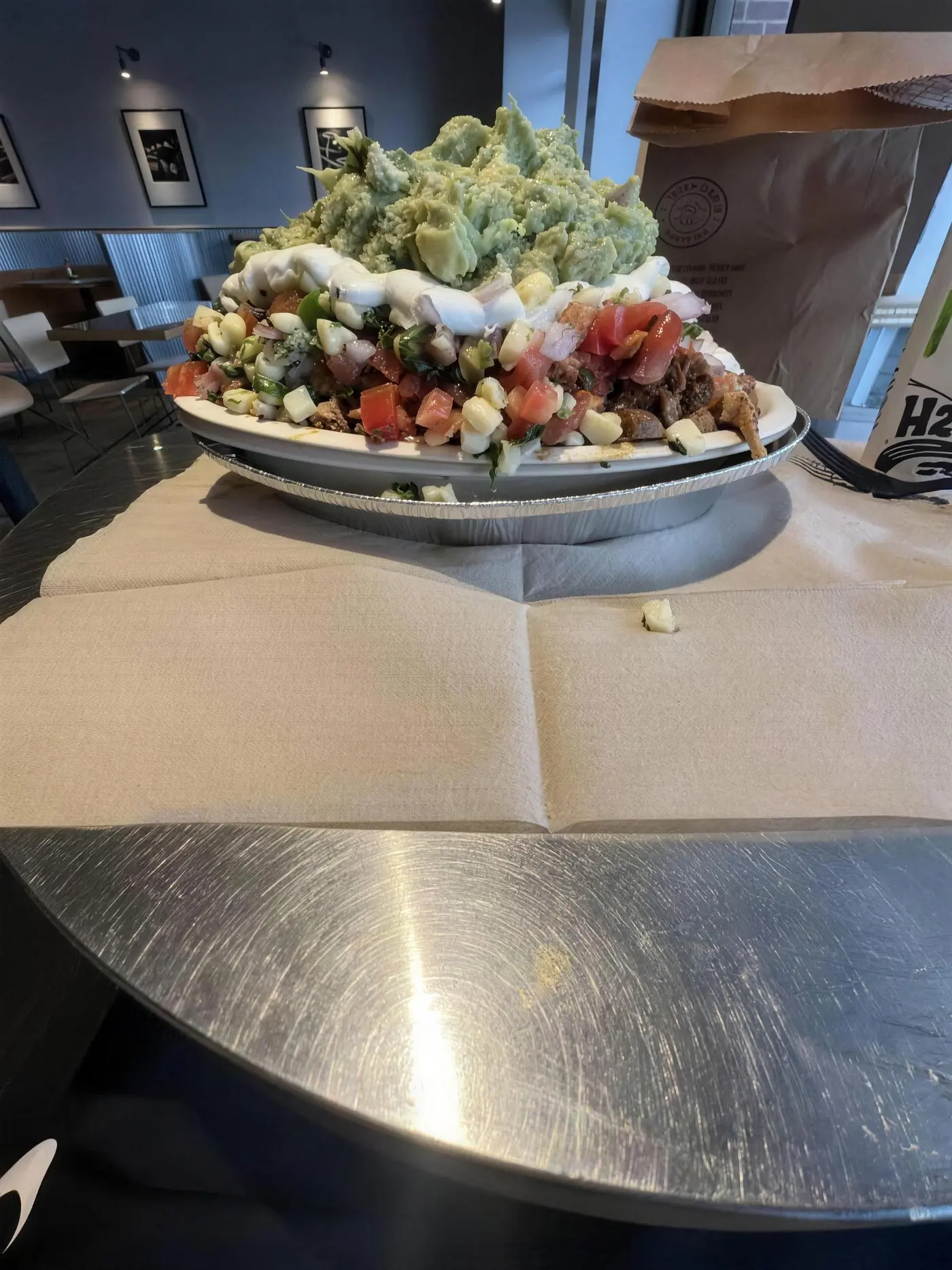Chipotle bowl stacked high with guacamole, sour cream, pico and steak